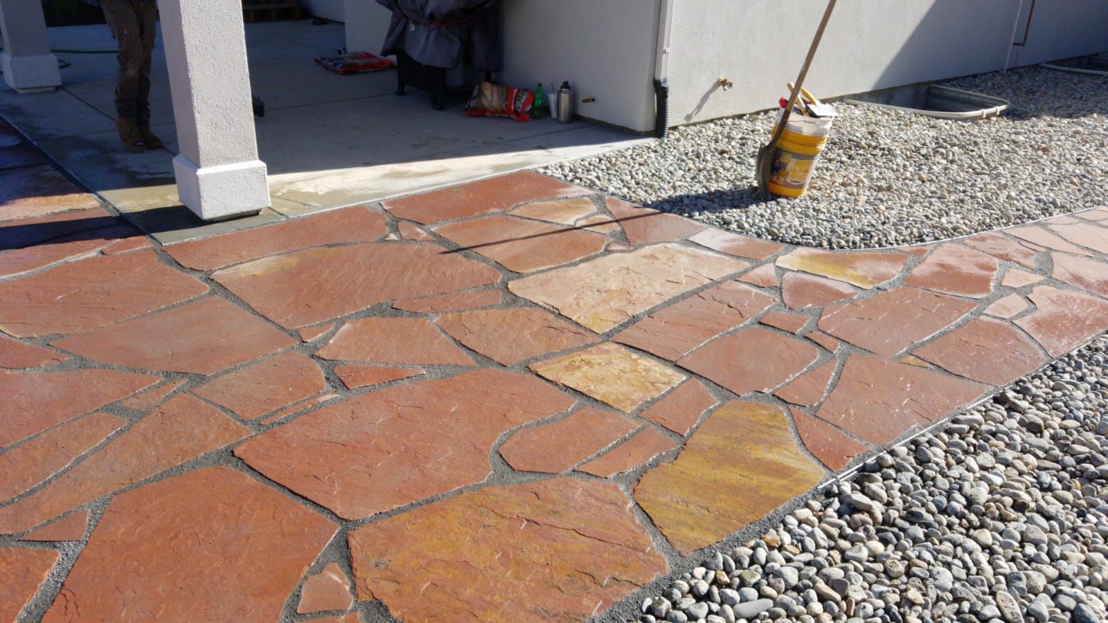 A brick walkway with a mop in the middle of it