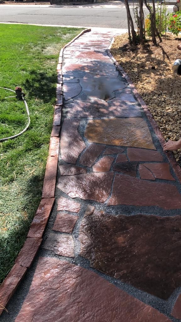 A stone walkway leading to a grassy yard.