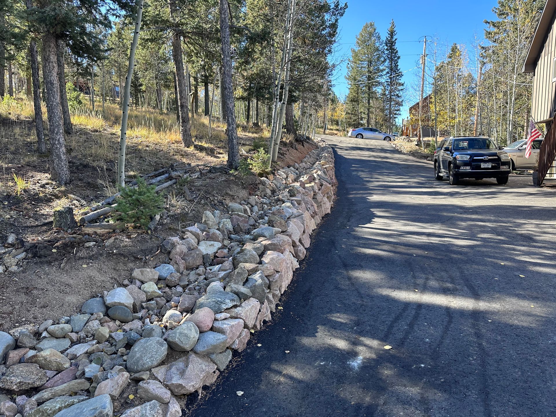 A black truck is parked on the side of a road
