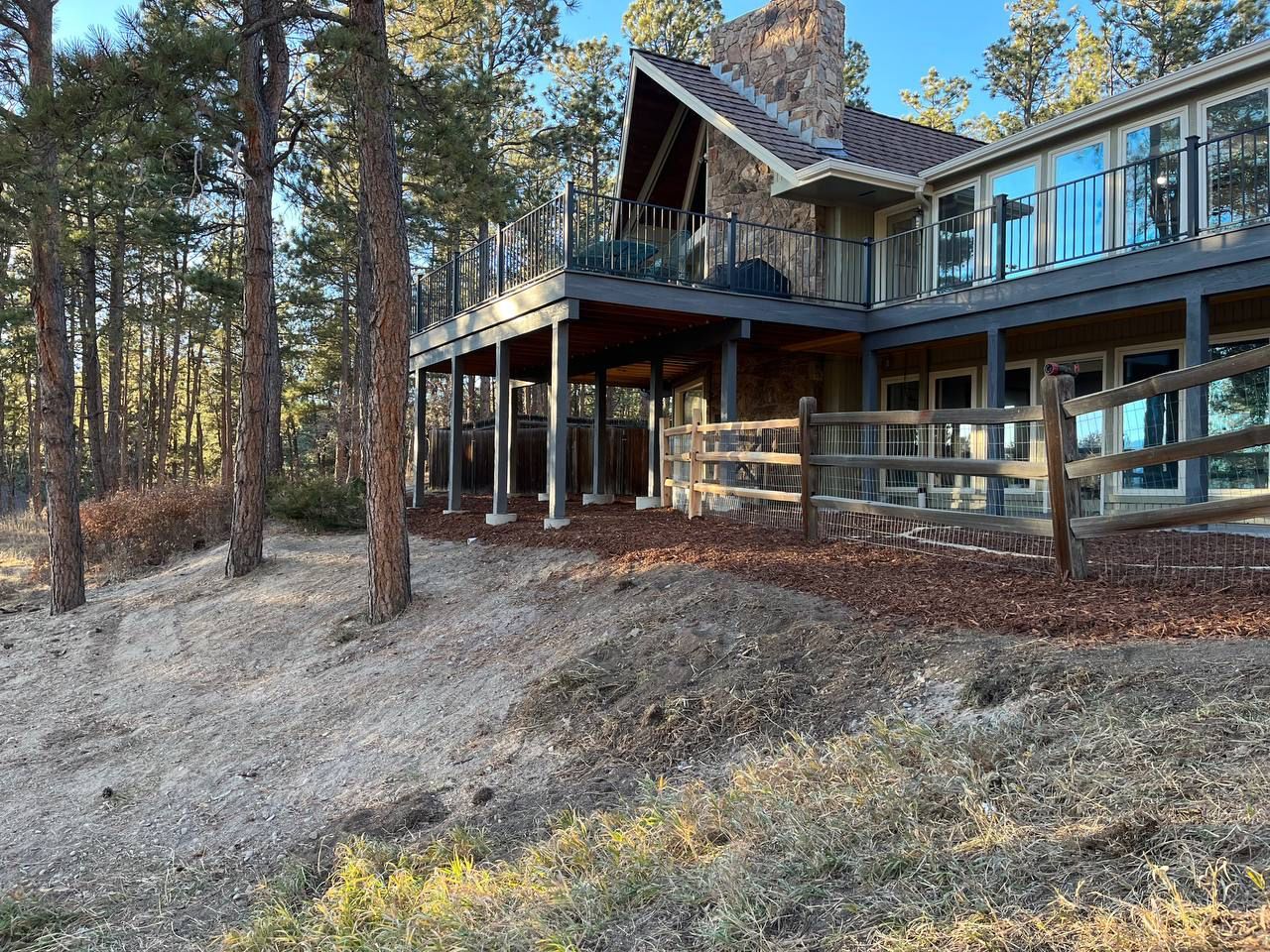 A large house with a wooden fence in front of it