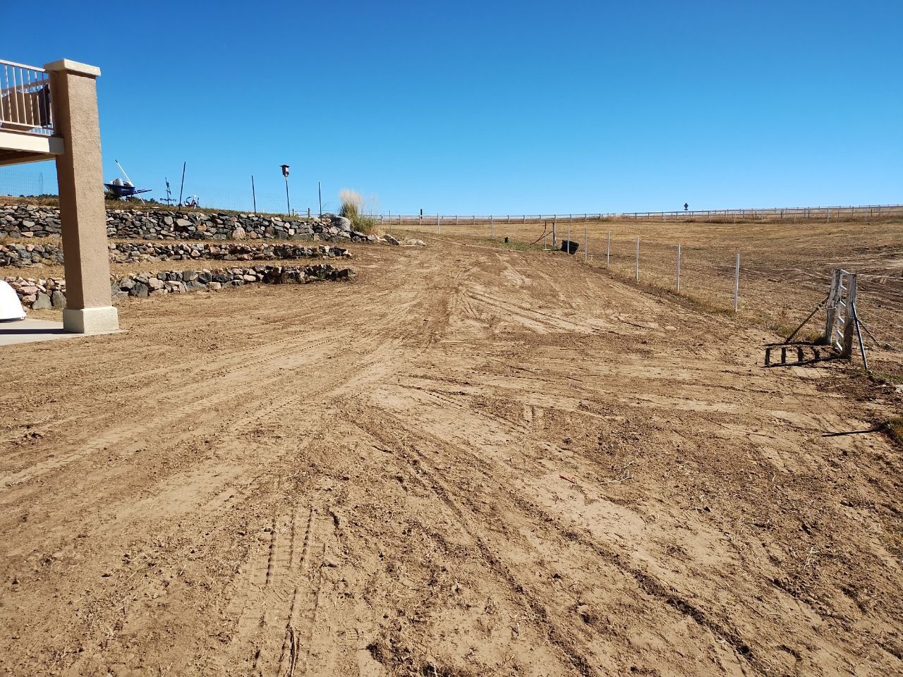 A dirt field with a few steps in the background