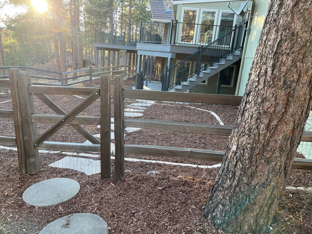 A wooden fence with a house in the background