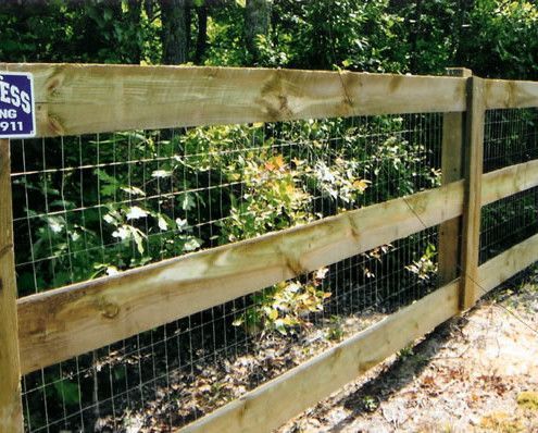 A wooden fence with a sticker on it that says emergency 911