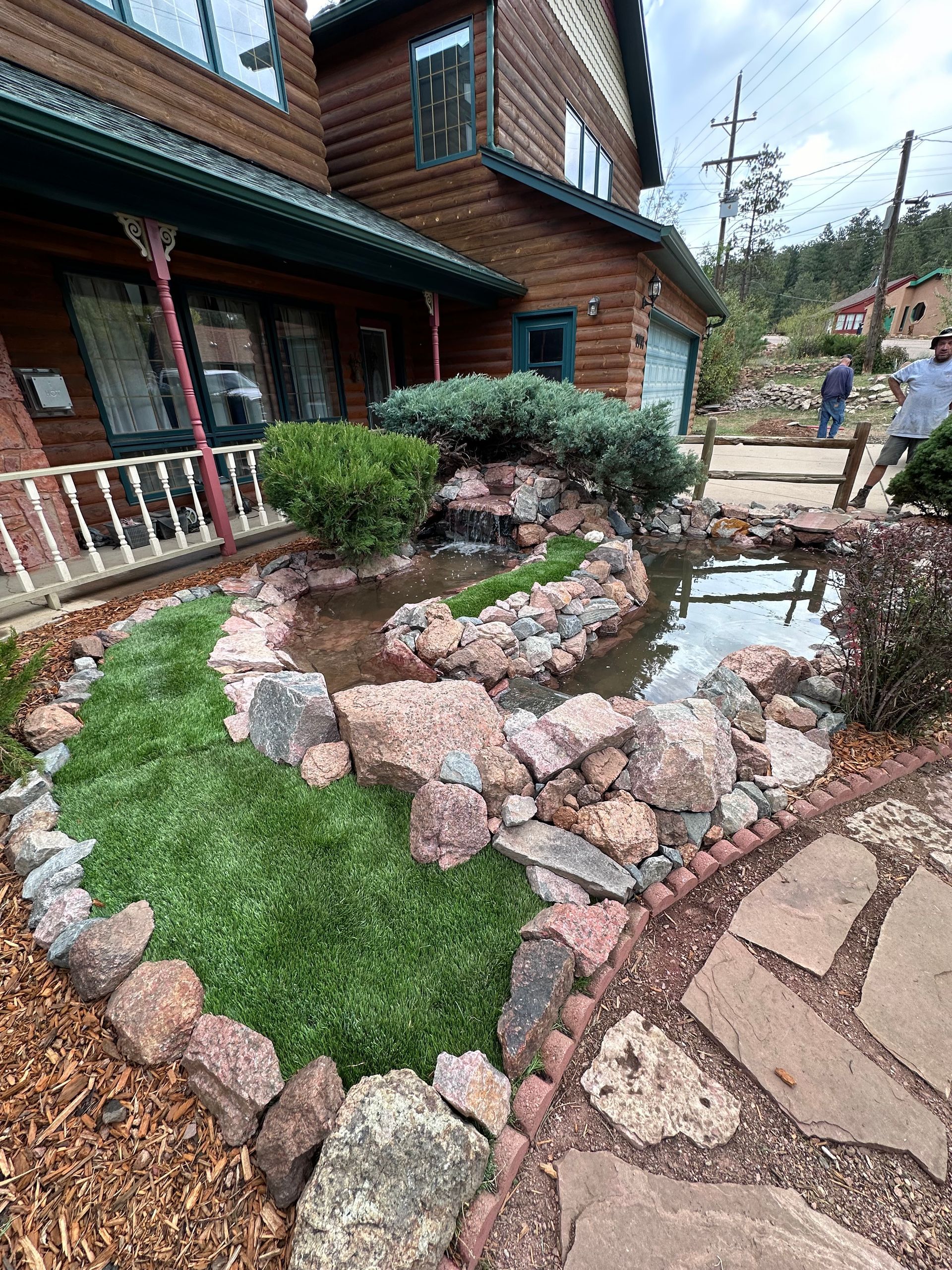 A house with a pond in front of it