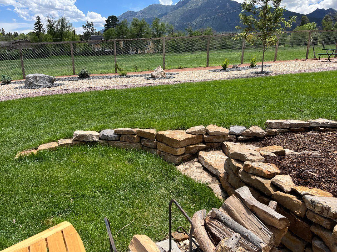 A lush green lawn with mountains in the background