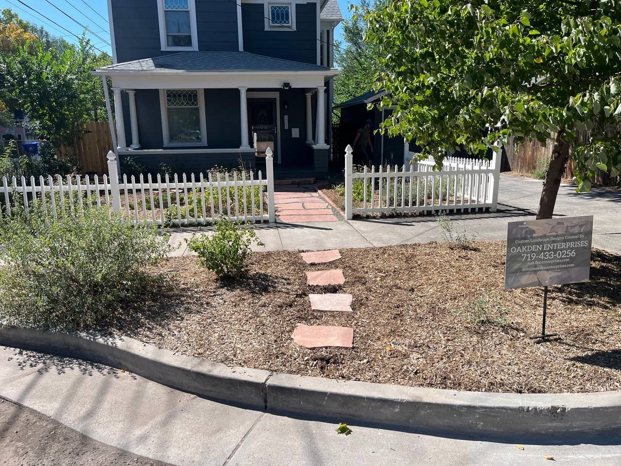 A house with a white picket fence is for sale