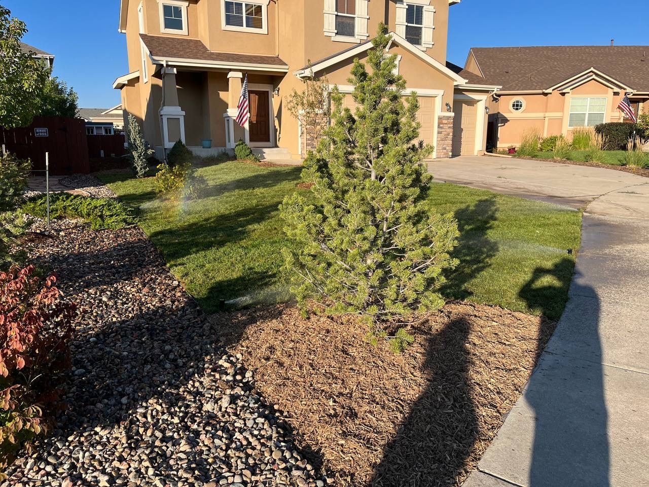A house with a sprinkler in front of it