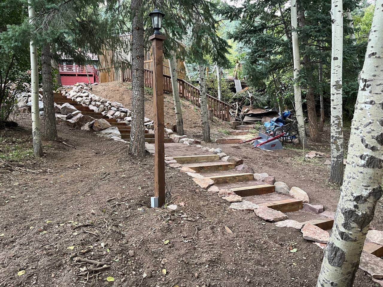 A set of stairs leading up to a house in the woods.