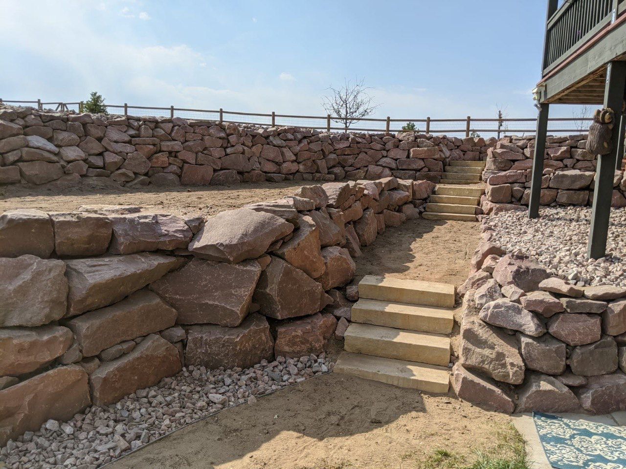 A stone wall with stairs leading up to it