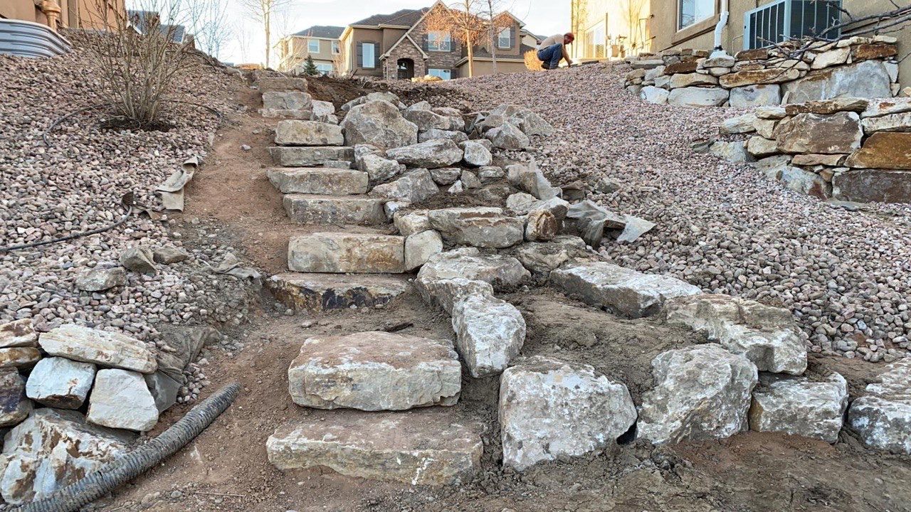 A pile of rocks is sitting on top of a dirt hill.