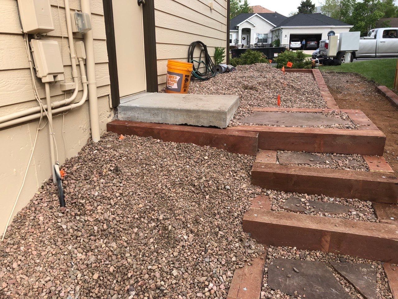 A brick walkway is being built in front of a house