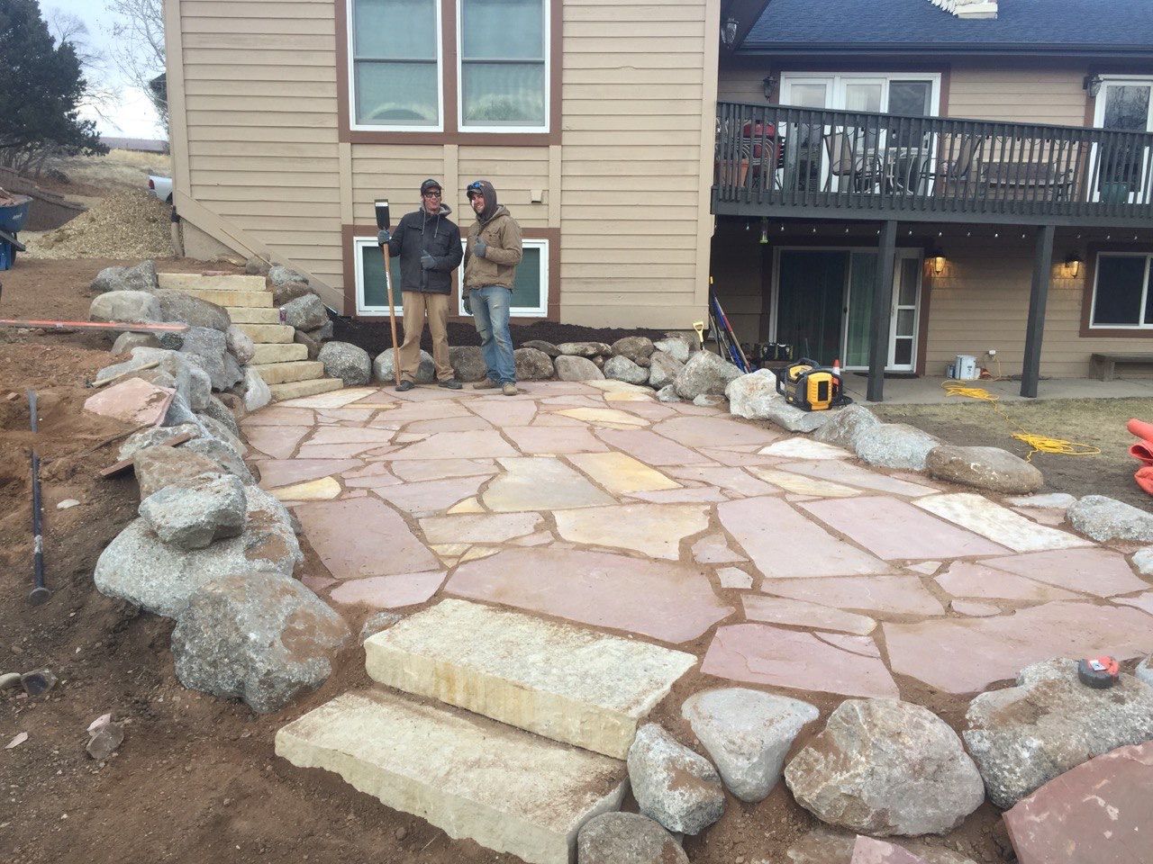 A couple of men standing in front of a house