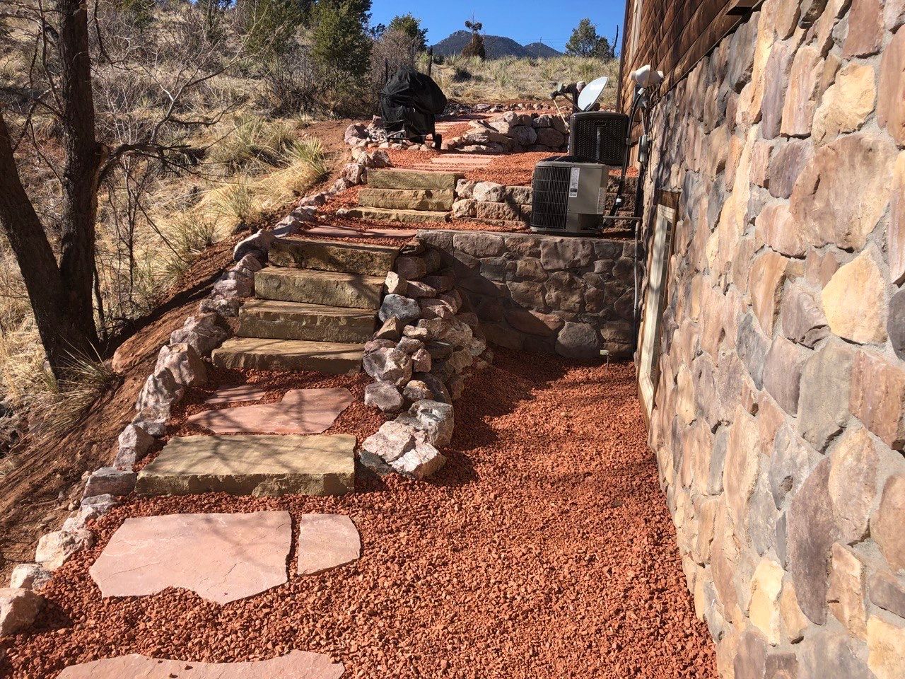 A stone wall with stairs leading up to it
