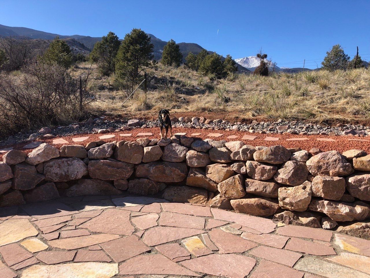 A stone wall with a mountain in the background