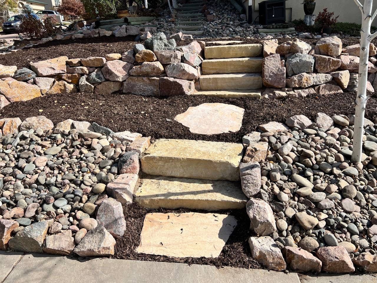 A stone walkway with stairs leading up to a house
