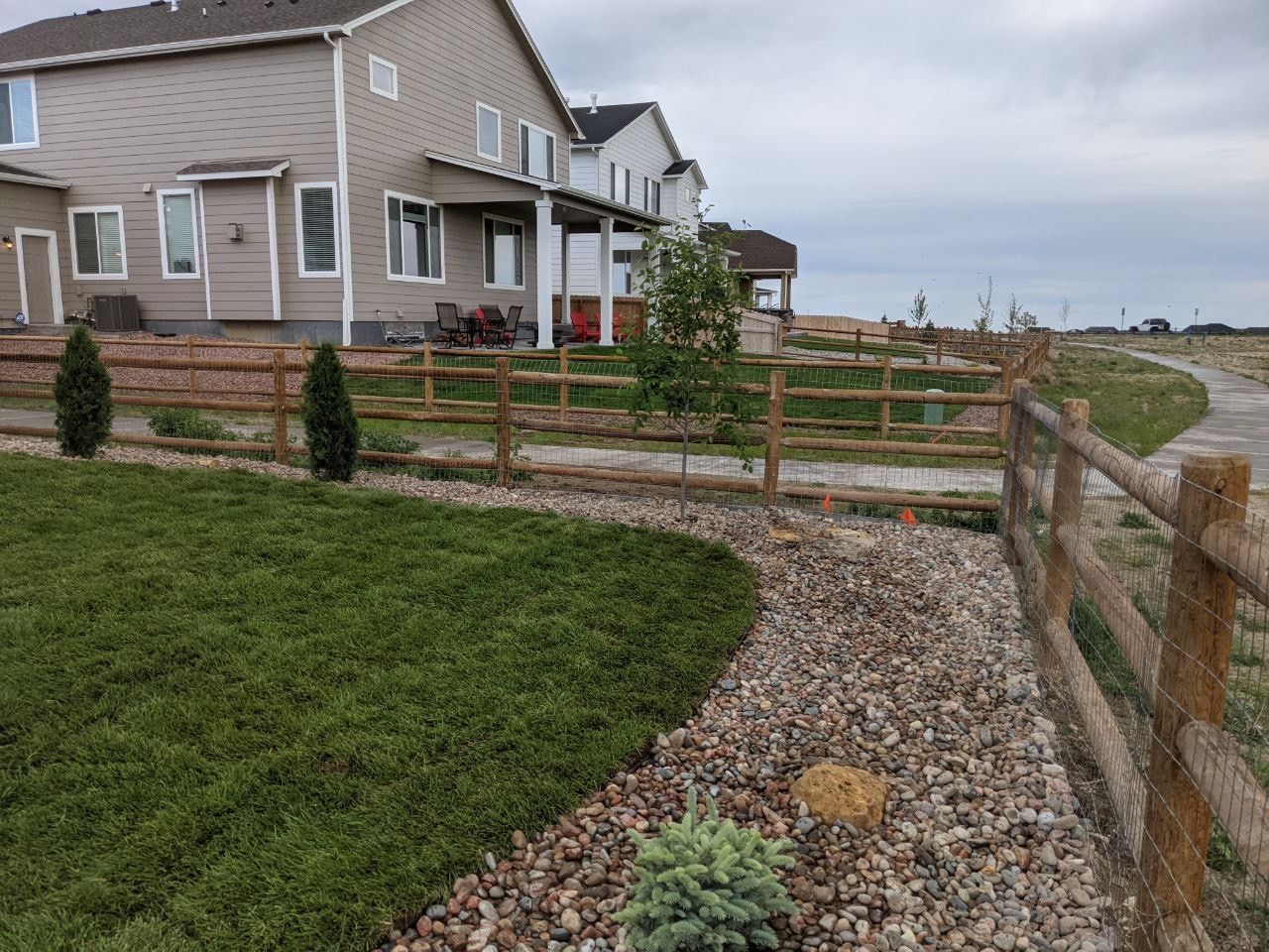 A house with a wooden fence in front of it