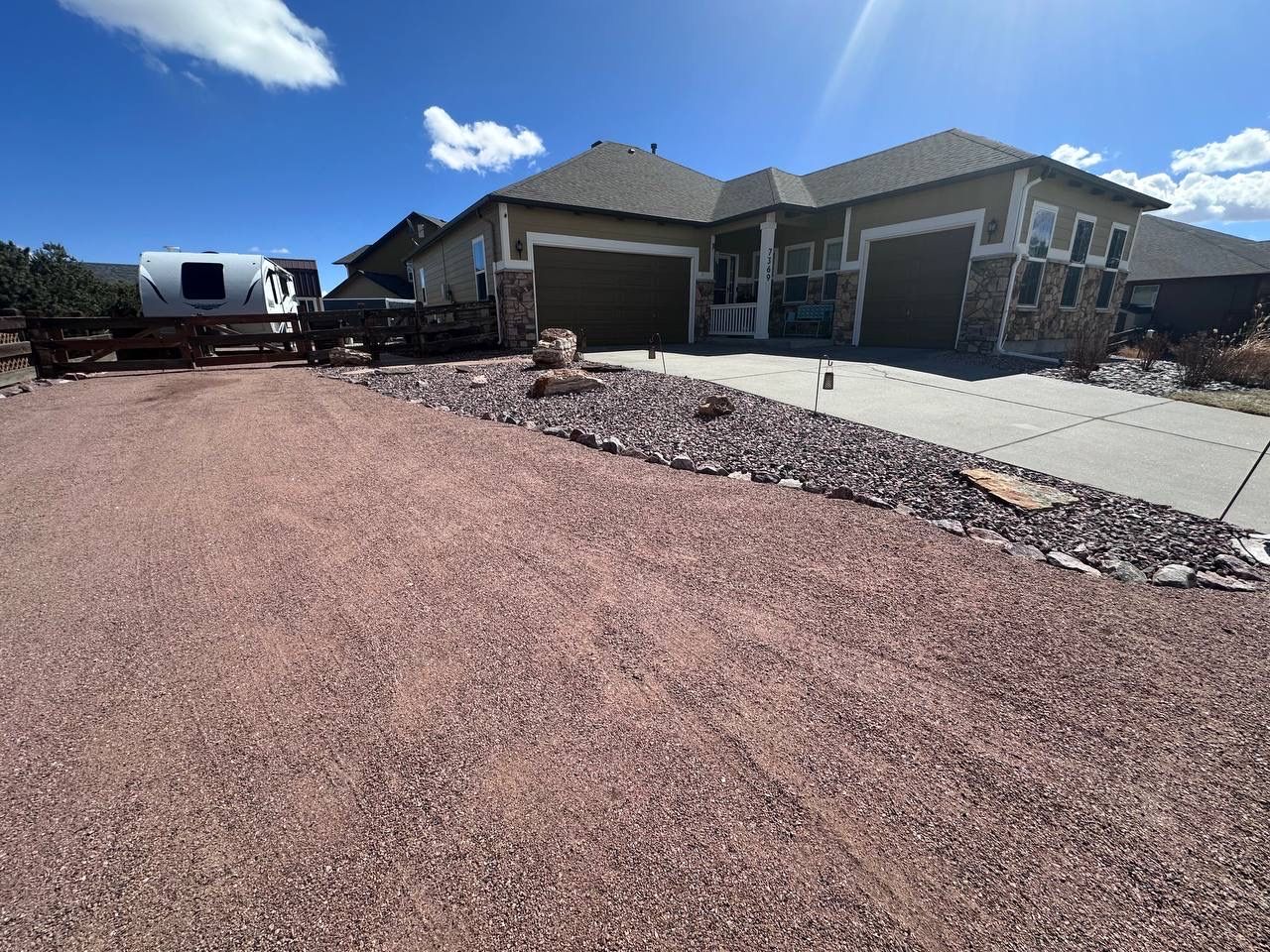 A house with a trailer parked in front of it