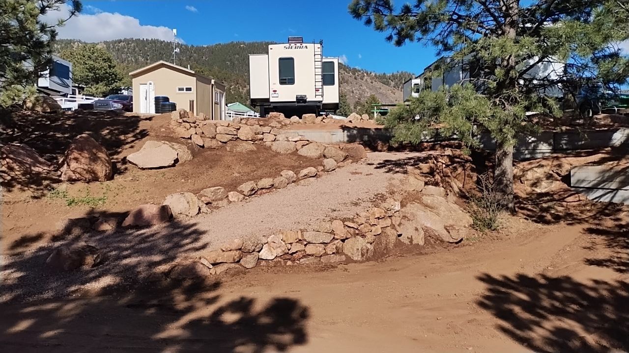 A large pile of dirt is in front of a house