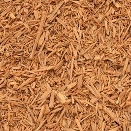 A pile of wood chips is sitting on the ground.