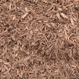 A pile of brown mulch is sitting on the ground.