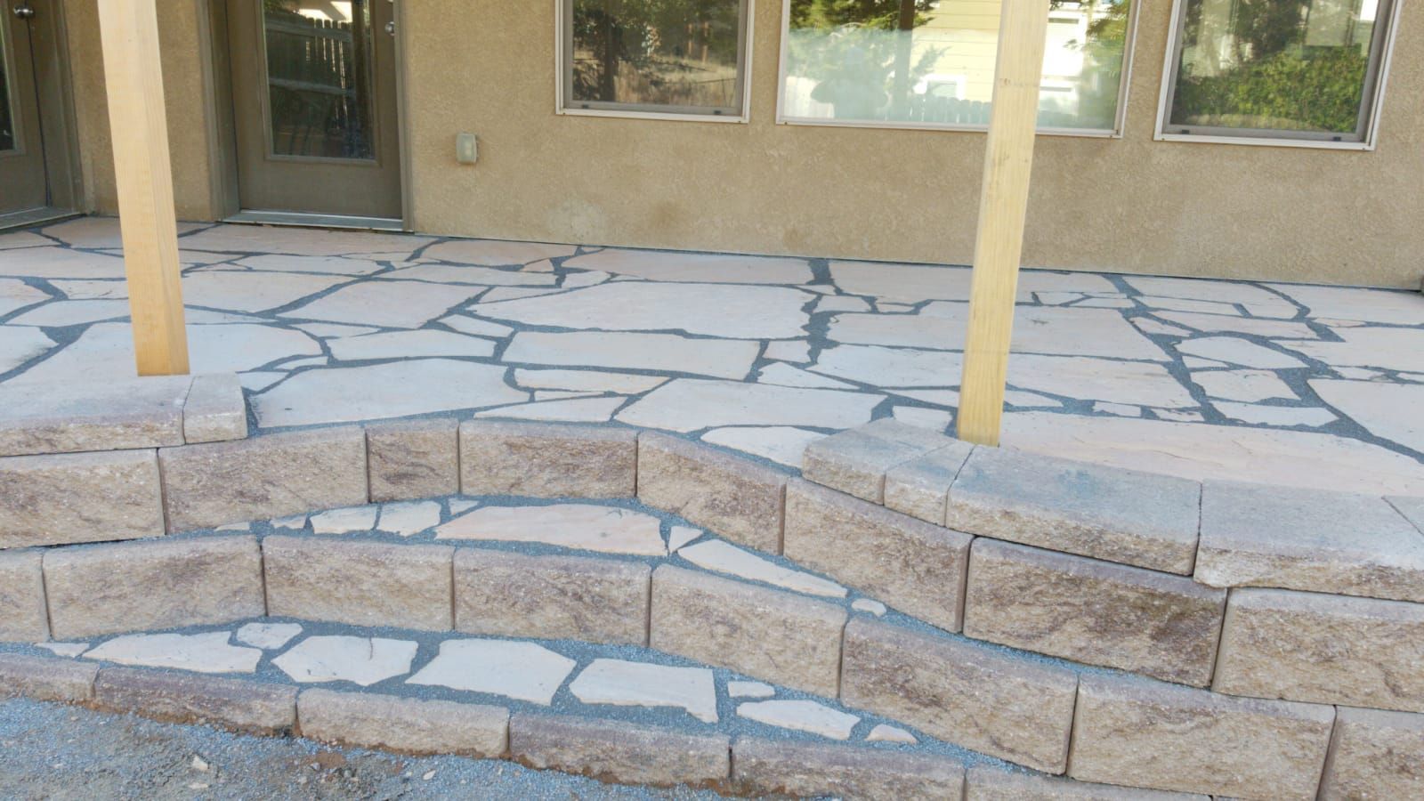 A stone patio with stairs leading up to it