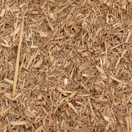 A pile of wood chips is sitting on the ground.