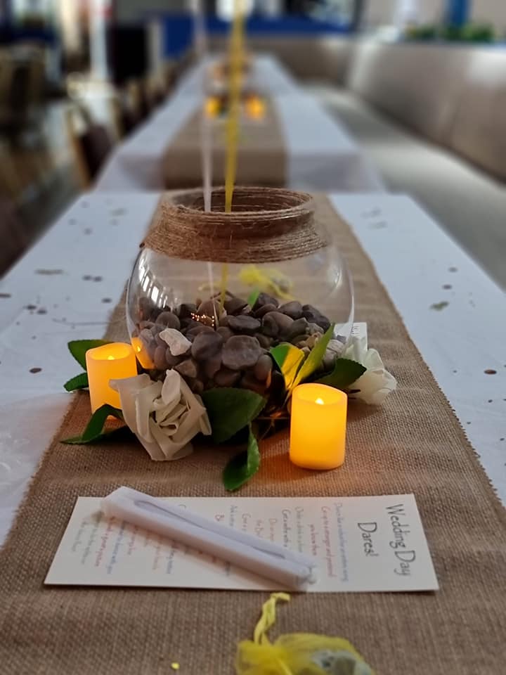 A table with candles and a wedding day card on it