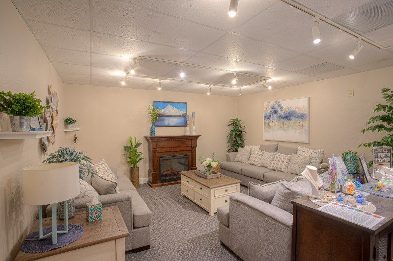 A living room filled with furniture and a fireplace.