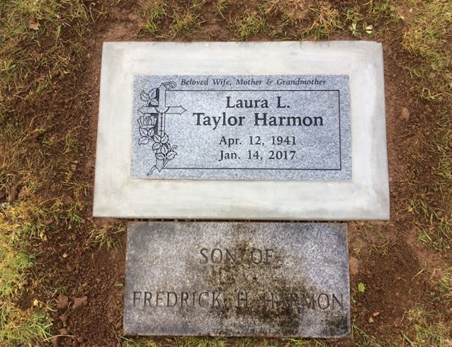 A gravestone for laura l. taylor harmon sits next to another gravestone
