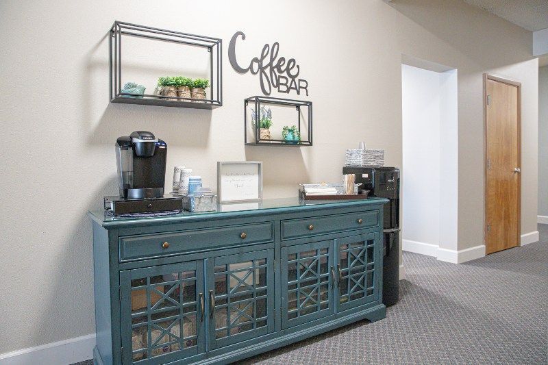 There is a coffee bar in the hallway of a building.