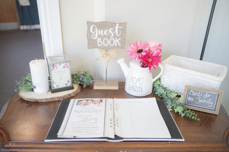 A guest book is sitting on top of a wooden table.