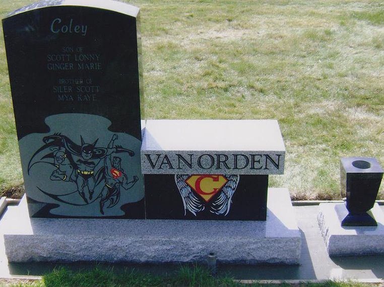 A grave for coley vanorden with a batman and superman design