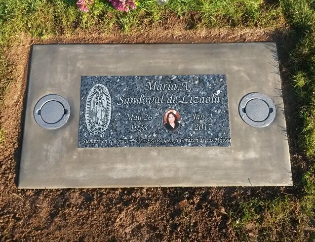 A grave in a cemetery with the name maria on it