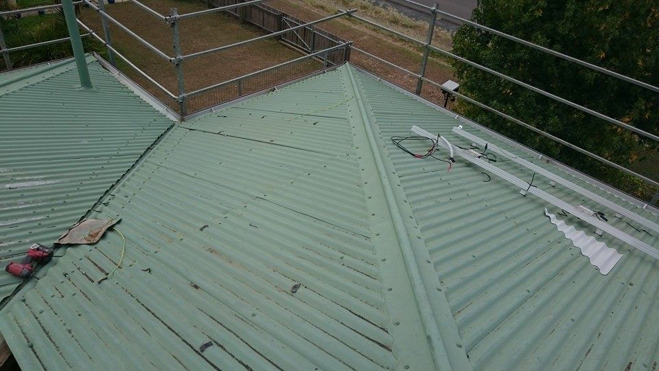 A Corrugated Metal Roof with Safety Railing — Kaplan Roofing in Walkervale, QLD