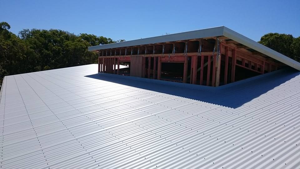 A Corrugated Metal Roof with Wooden Framework — Kaplan Roofing in Walkervale, QLD