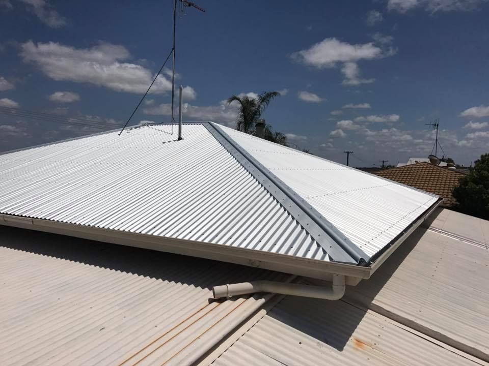 A Metal Roof with Antenna,  and Gutters — Kaplan Roofing in Walkervale, QLD