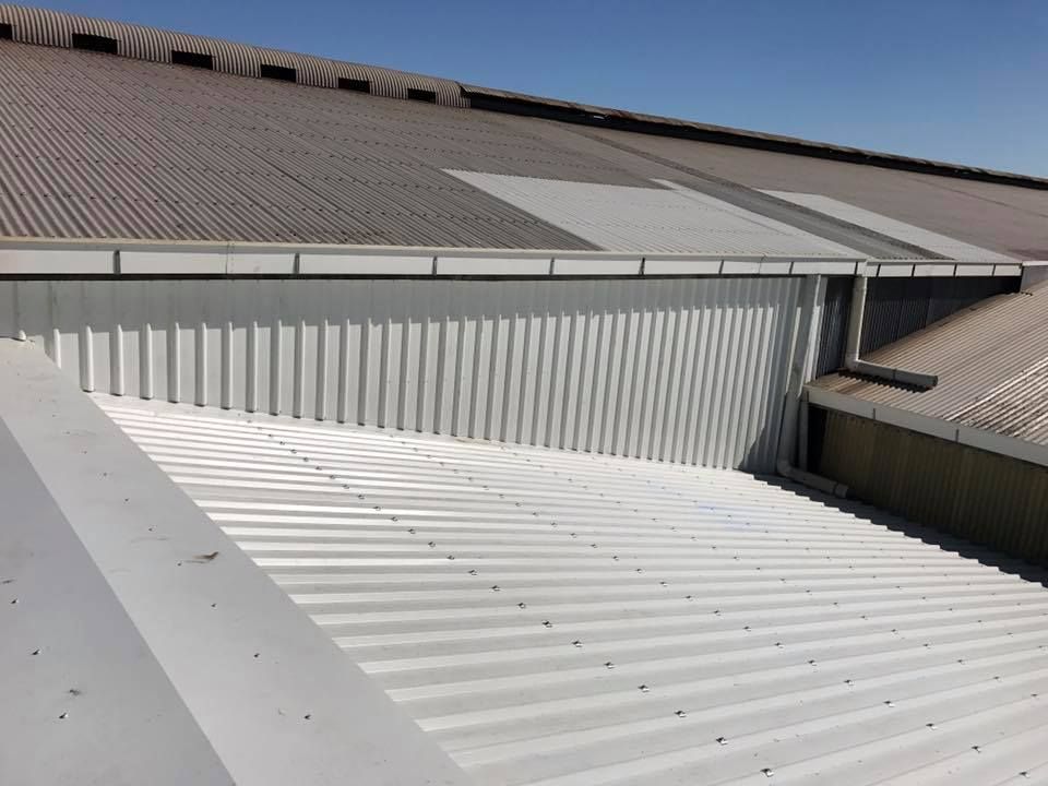 A Corrugated Metal Roof with Gutter — Kaplan Roofing in Walkervale, QLD