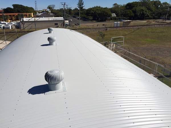 A Curved Metal Roof with Three Ventilation Turbines — Kaplan Roofing in Walkervale, QLD