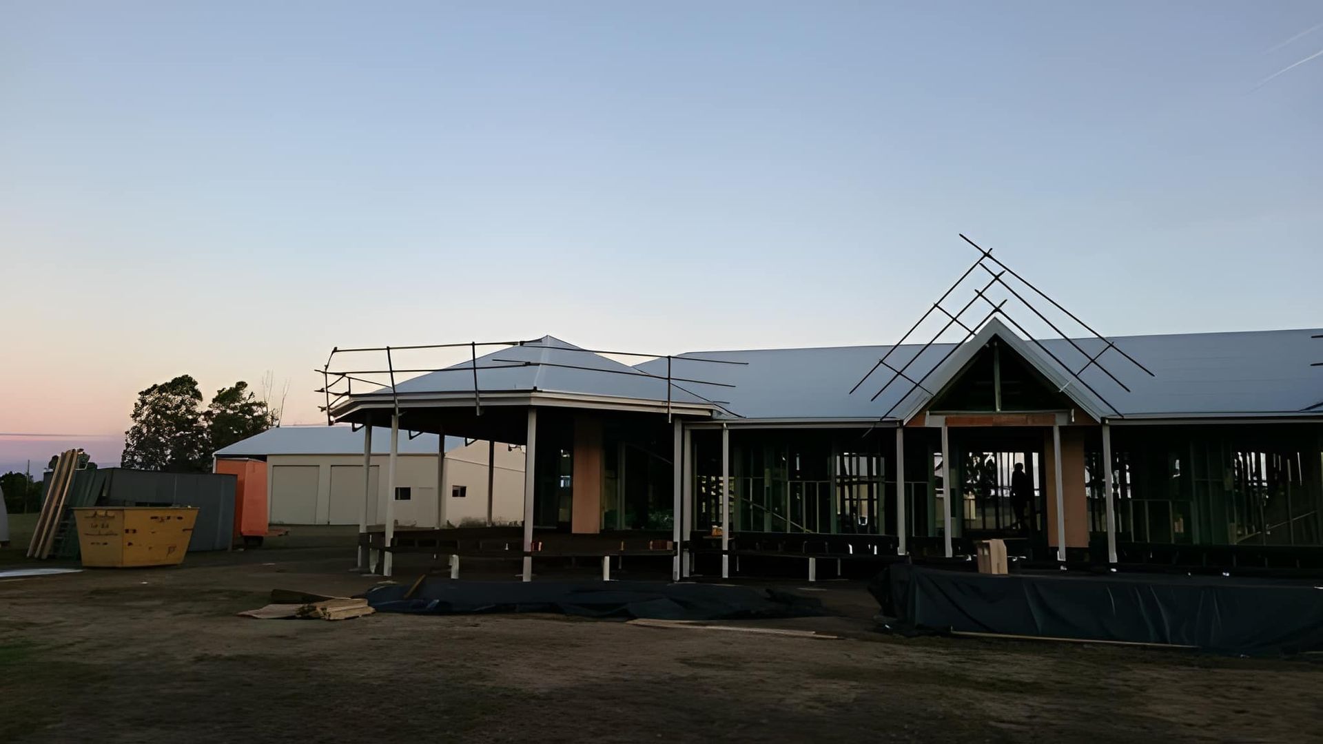 A House Under Construction at Dusk — Kaplan Roofing in Walkervale, QLD