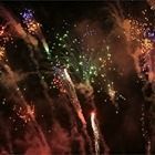 Colorful fireworks bursting against a dark night sky