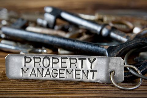 Property Management Sign with Keys on Desk
