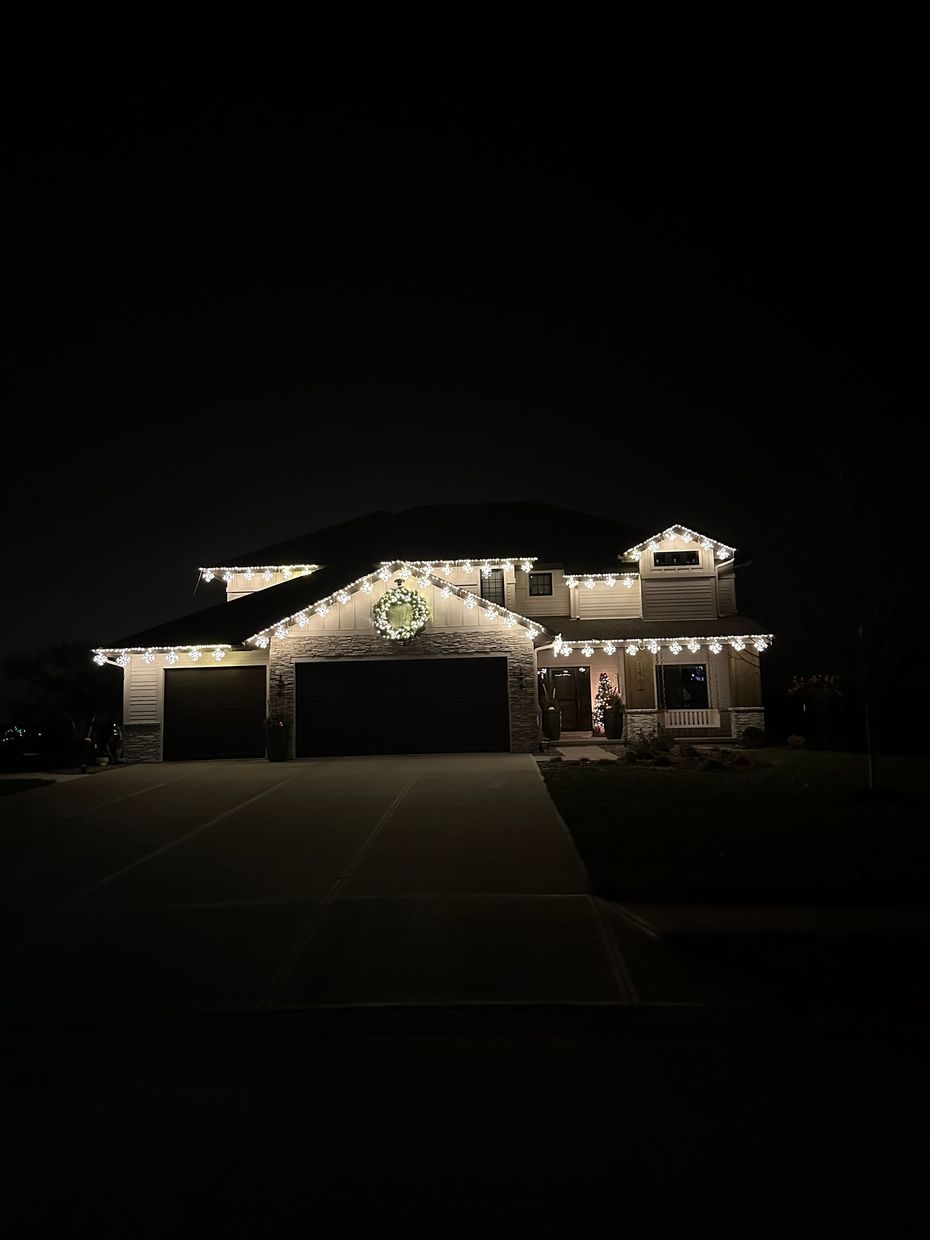 Christmas Lights being hung from a house