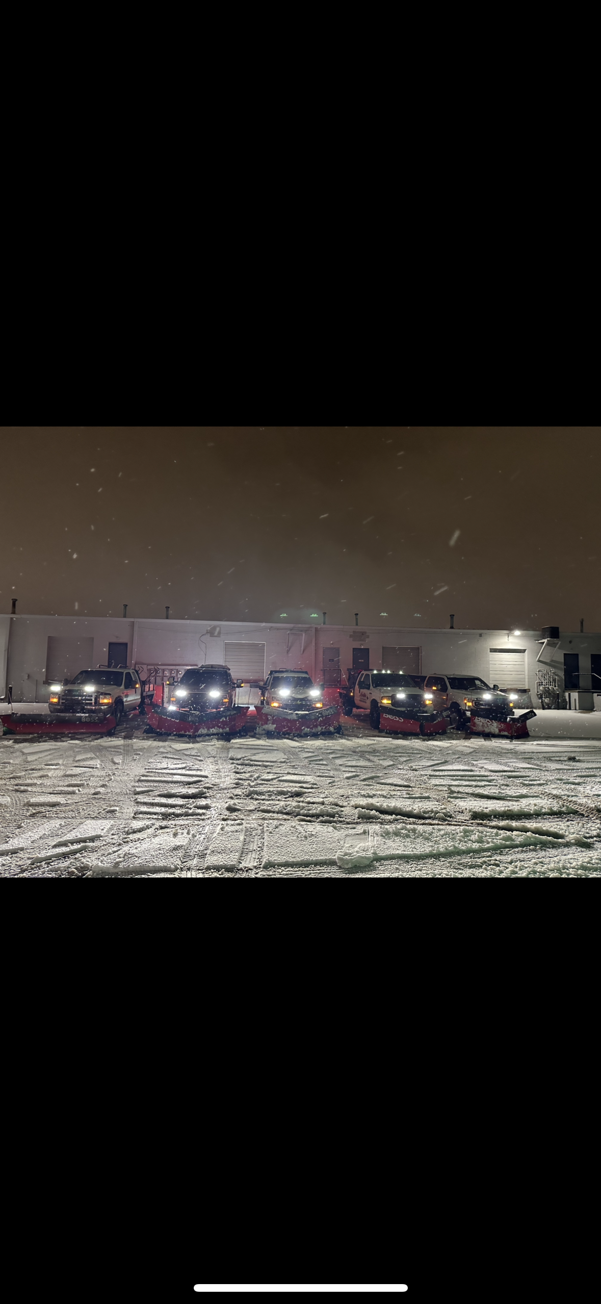 Company snow plowing vehicles