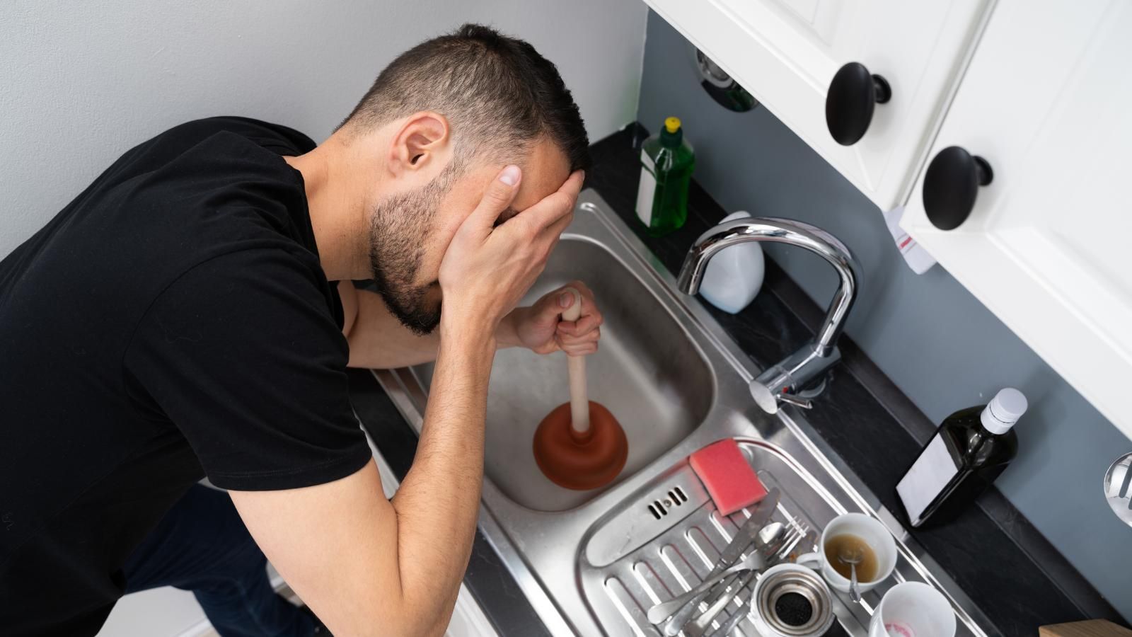 Exasperated man with a clogged sink