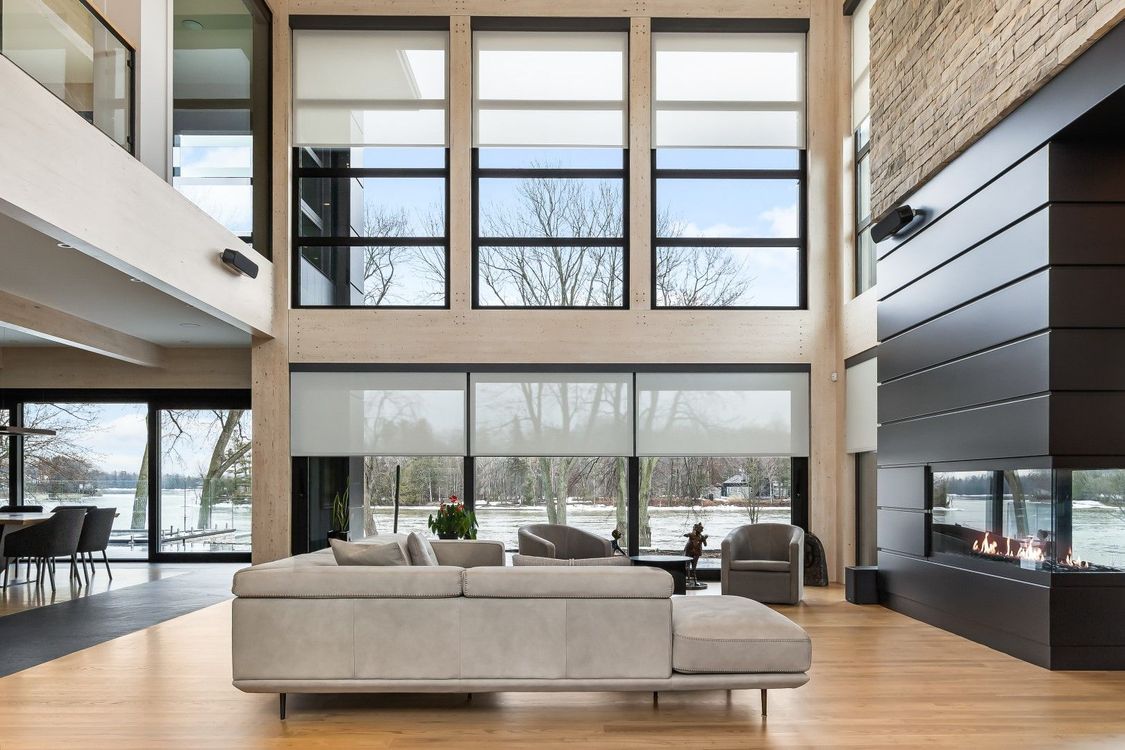 A living room with a couch , chairs , and a fireplace.