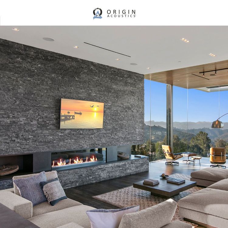 A living room with a fireplace and a flat screen tv
