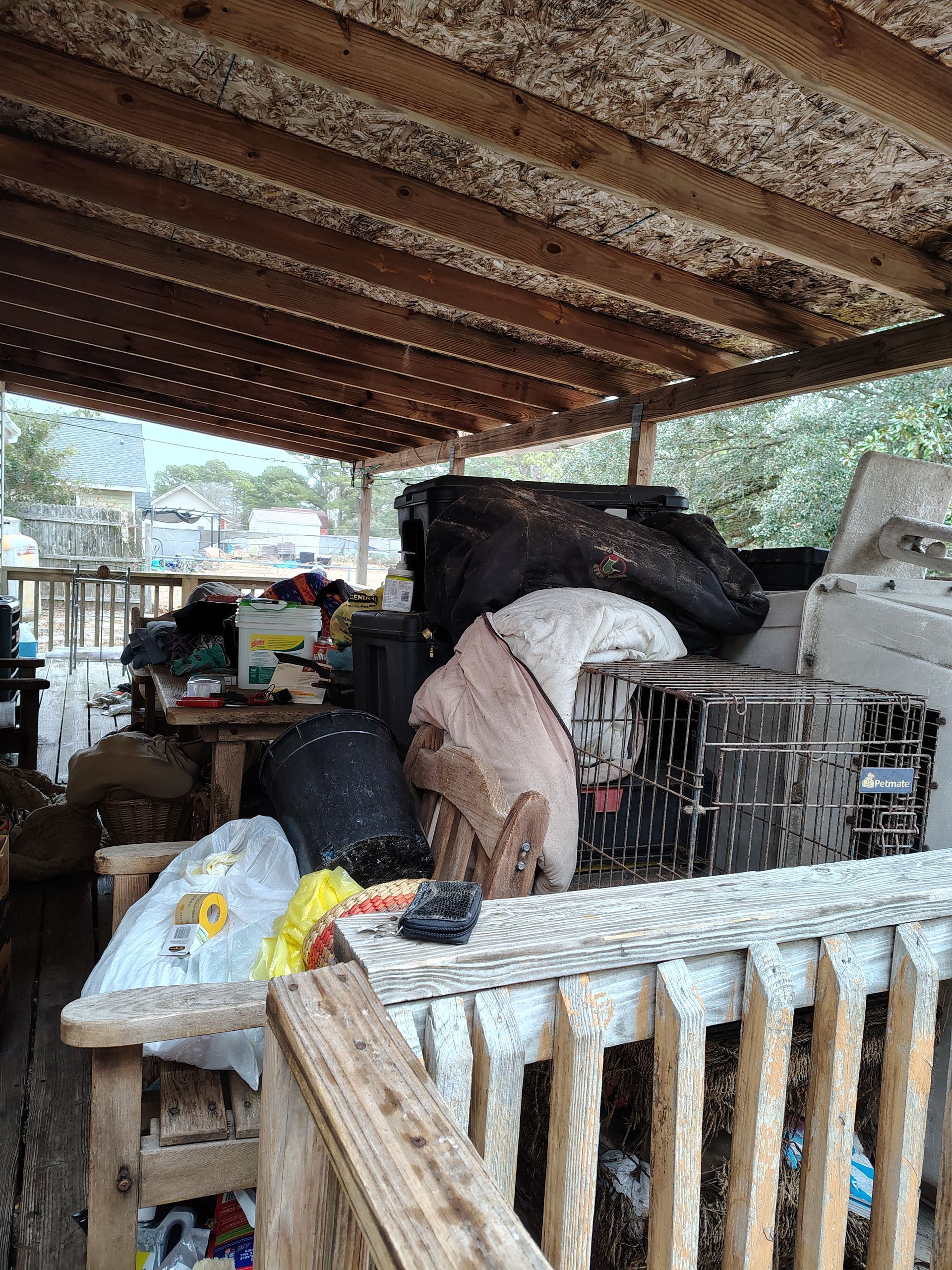 A wooden deck with a lot of trash on it.