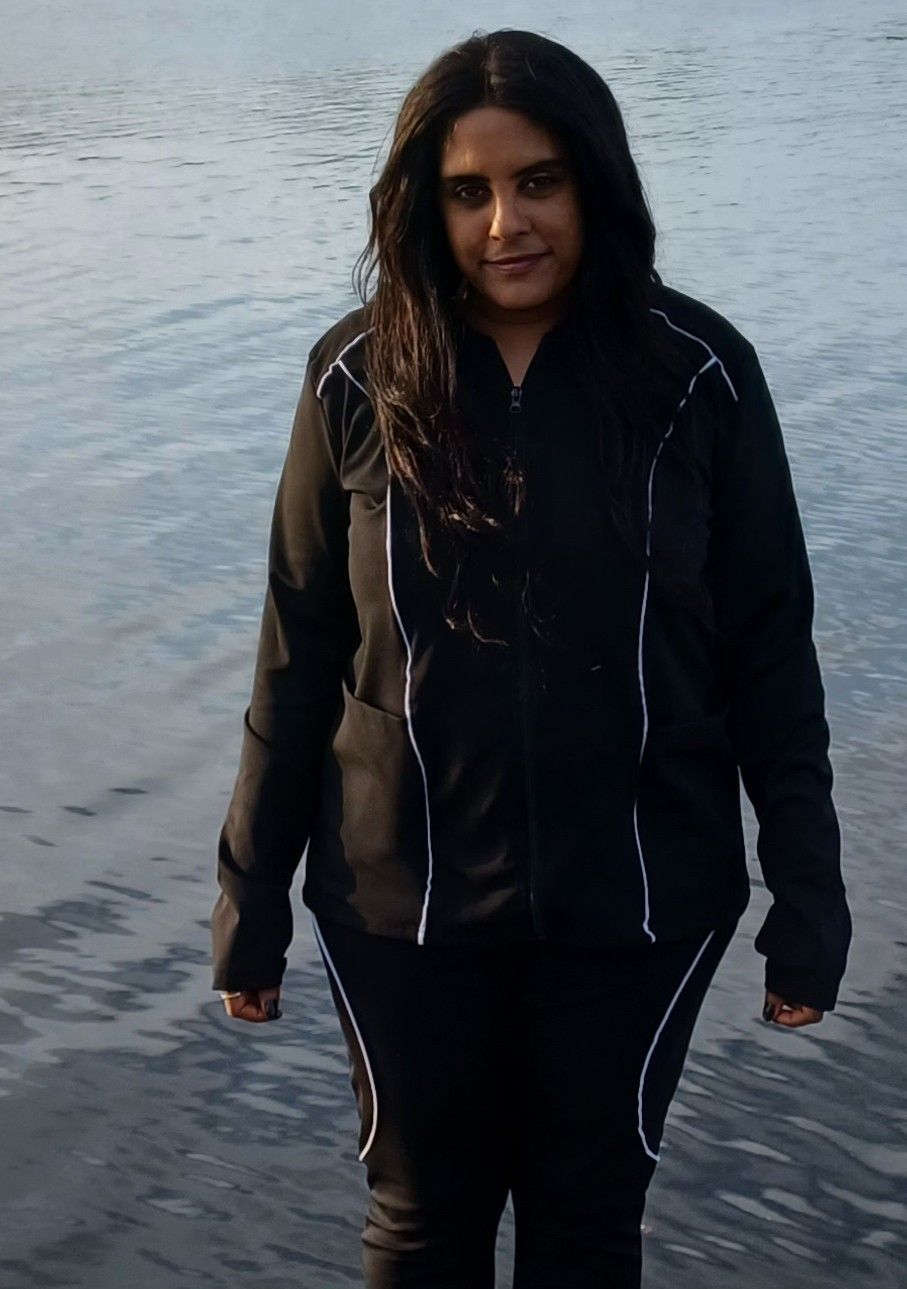 A pile of junk is sitting on the sidewalk in front of a house.