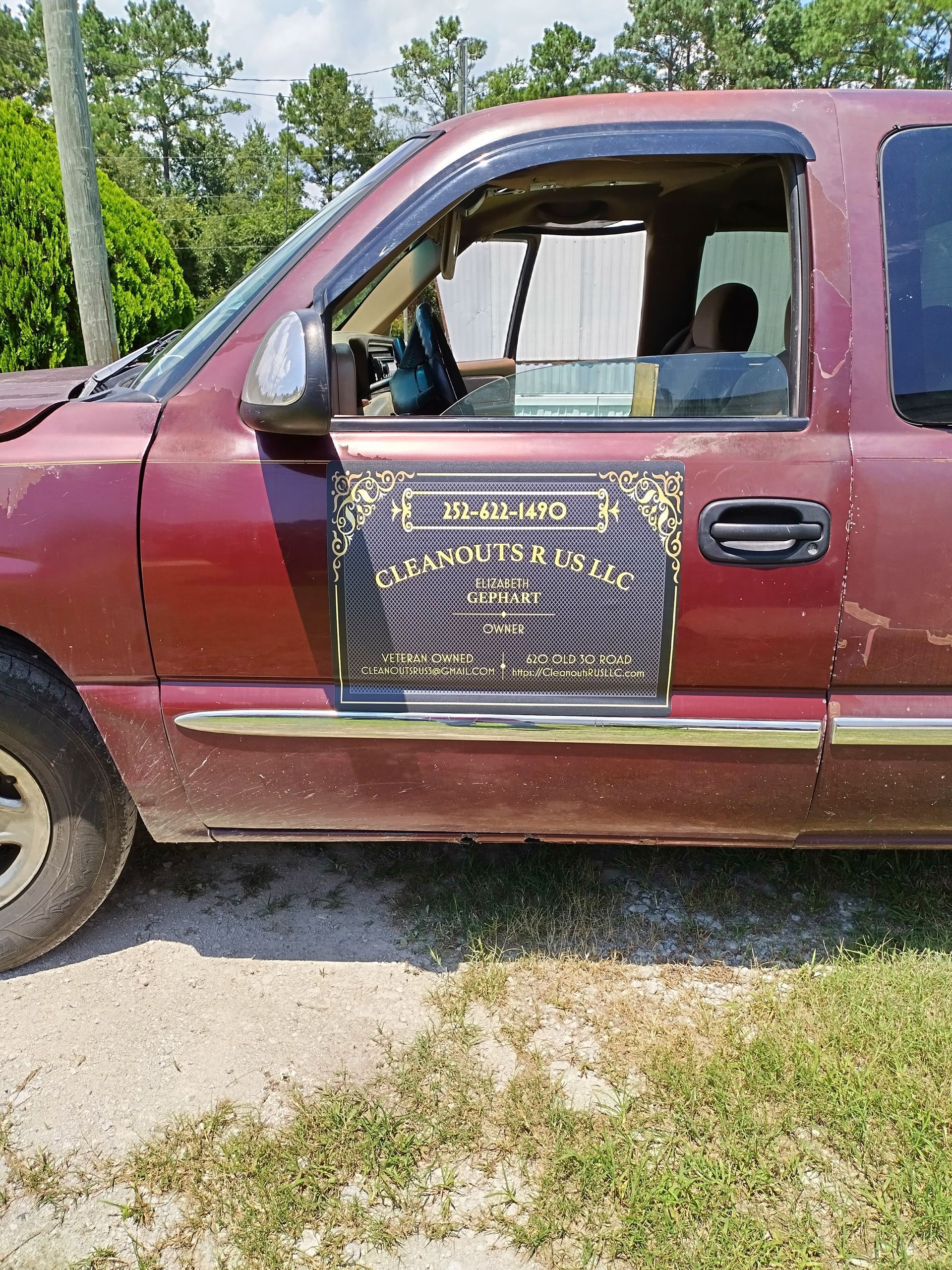 A red truck is parked on the side of the road.