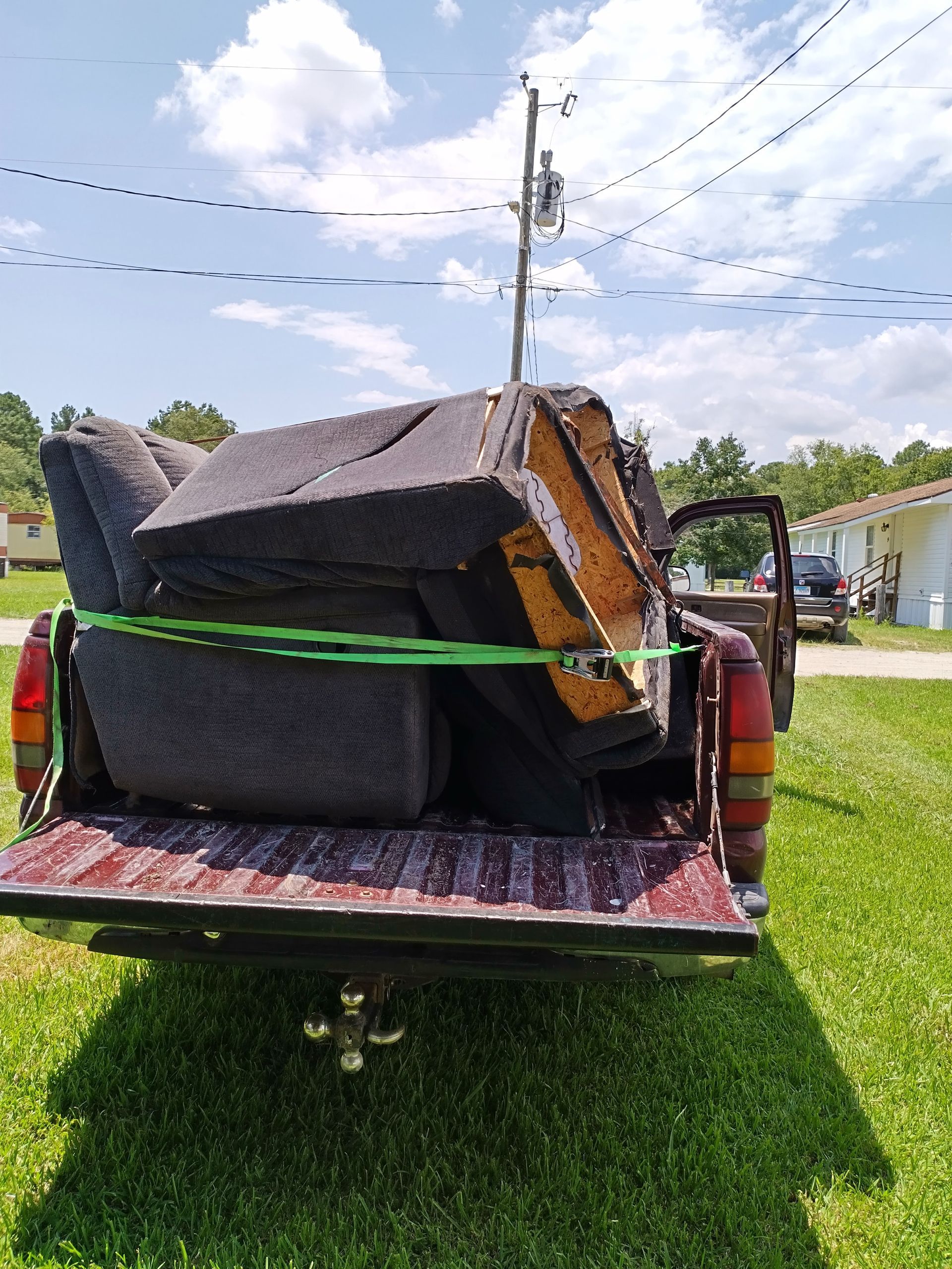 A truck with a couch in the back of it